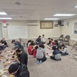 Families and community members sharing a meal at Dar Ussalam