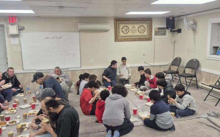 Families and community members sharing a meal at Dar Ussalam