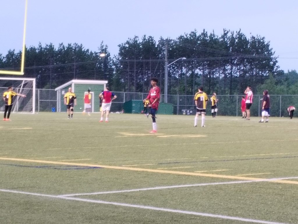 Youth playing soccer in a Dar Ussalam sports activity
